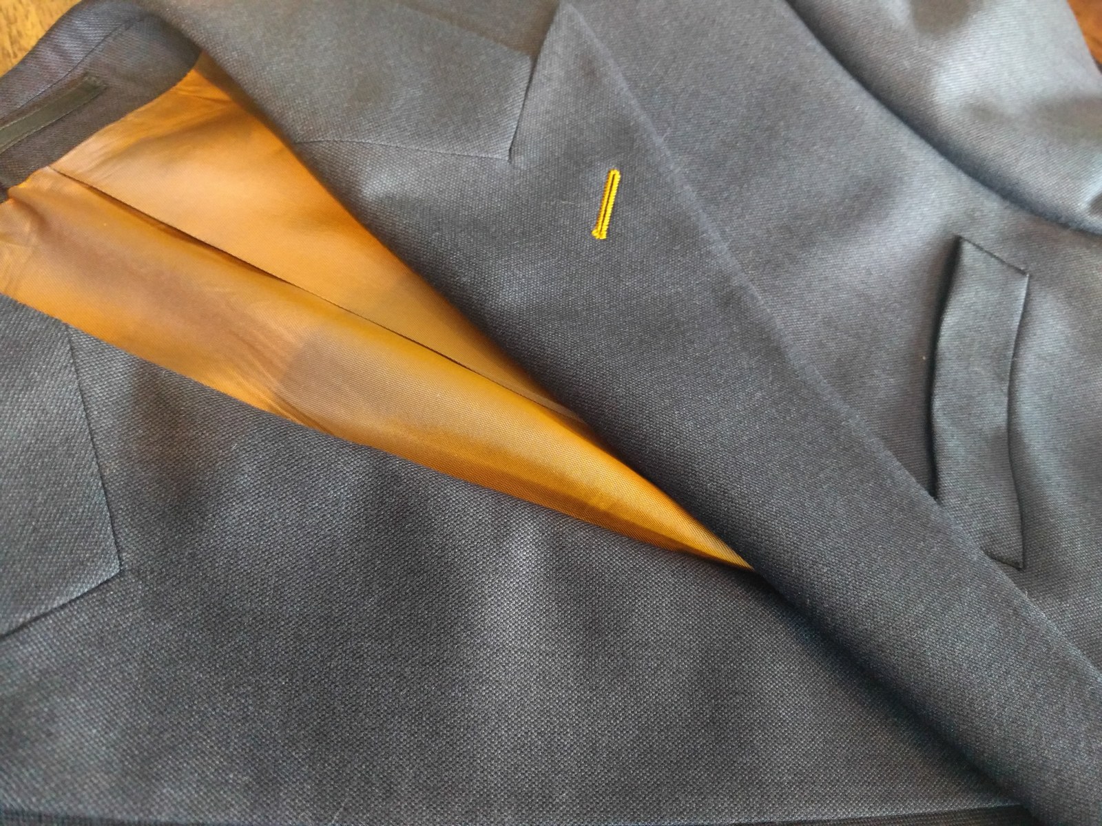 A finished hand-cut semi-bespoke grey two-piece from the Famous 1886 workshop